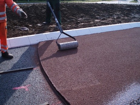 Roter StreetPhalt Gussasphalt mit Kunststoff ummanteltem Splitt